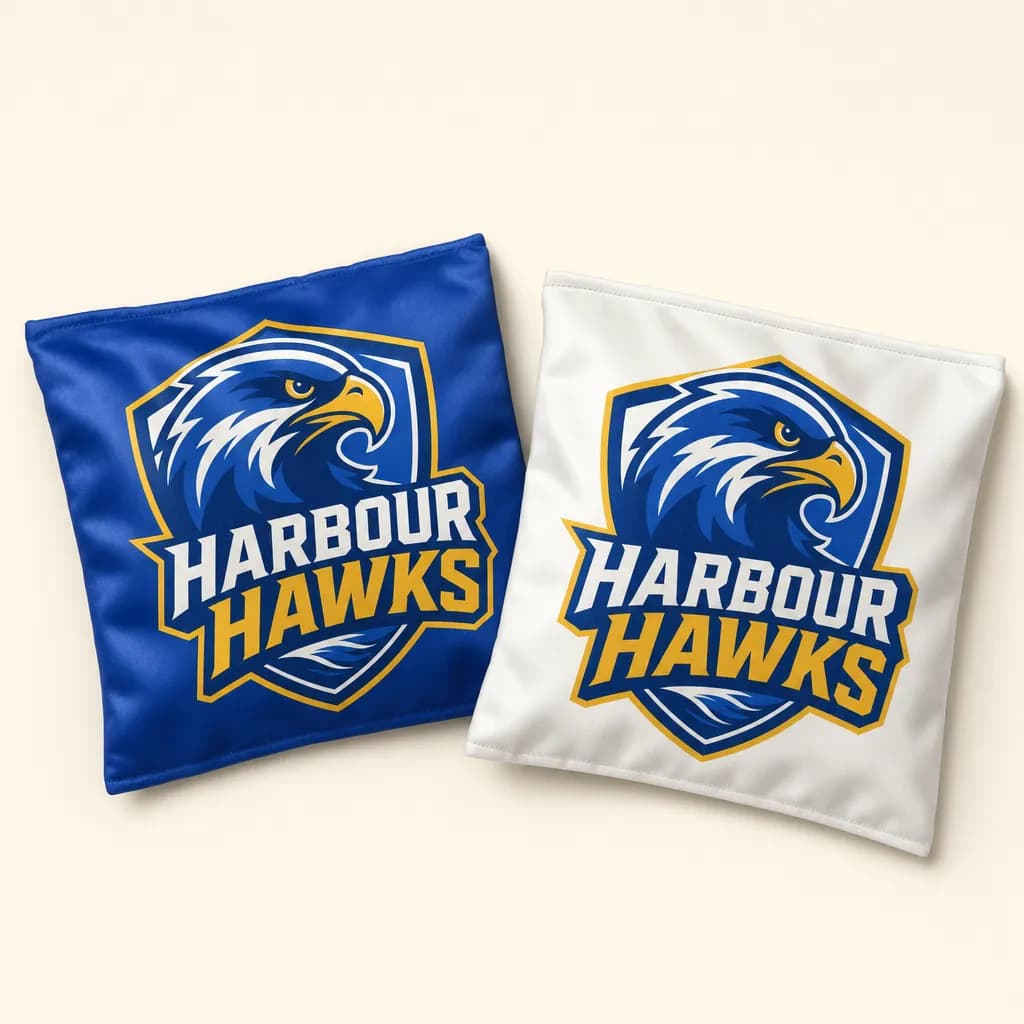 Royal blue and white cornhole bags printed with a team crest
